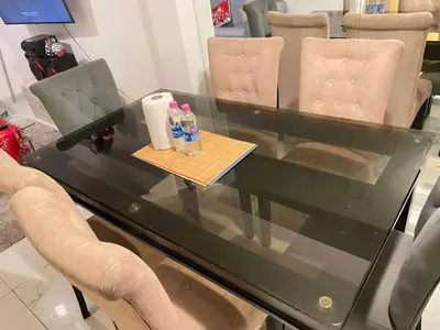 a glass table with chairs and drinks on it at El encanto de viajar in Lima