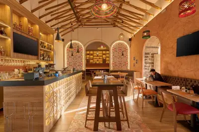 a restaurant with tables and chairs and a bar at Casa Andina Standard Ayacucho in Ayacucho