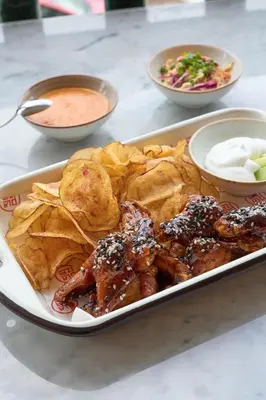 a tray of food with meat and chips and dip at Casa Andina Standard Ayacucho in Ayacucho