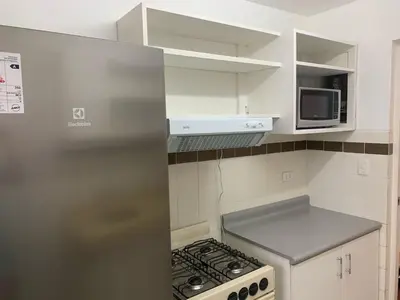 a kitchen with a stainless steel refrigerator and a microwave at Departamento en Miraflores in Lima
