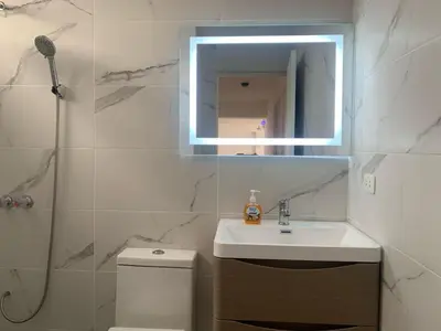 a bathroom with a sink and a mirror and a toilet at Departamento en Miraflores in Lima