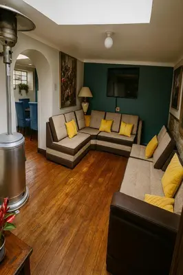 a living room with couches and yellow pillows at Panay Golden in Cusco