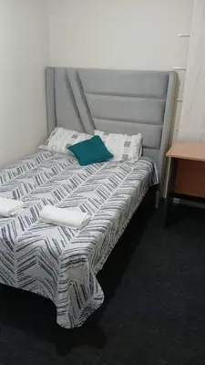 a bed in a hotel room with a blue pillow at Departamento en Miraflores, Lima 3HAB in Lima