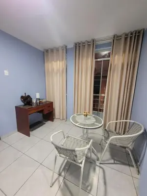 a room with a table and chairs and a desk at AlojamientoMarín in Lima