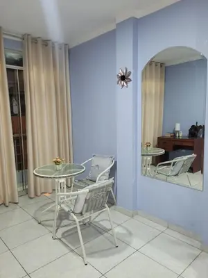 a table and chairs in a room with a mirror at AlojamientoMarín in Lima