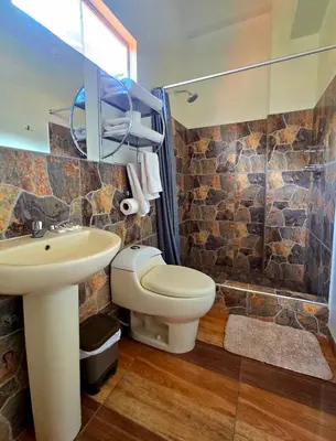 a bathroom with a toilet and a sink and a shower at Loft Casa Yucay in Yucay