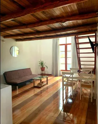 a living room with a couch and a table at Loft Casa Yucay in Yucay