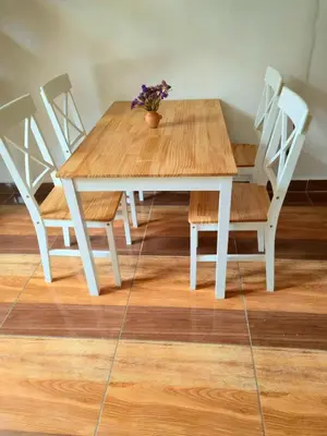 a wooden table with chairs and a potted plant on it at Loft Casa Yucay in Yucay