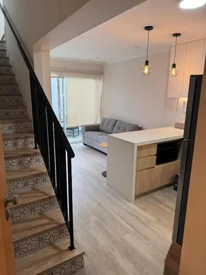 a kitchen and living room with a staircase in a house at Exclusive apartment Barranco! in Lima