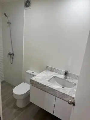 a white bathroom with a toilet and a sink at Exclusive apartment Barranco! in Lima