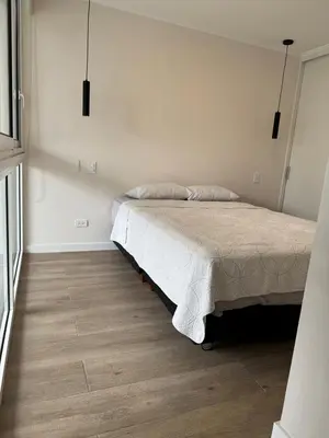 a bedroom with a bed and a wooden floor at Exclusive apartment Barranco! in Lima