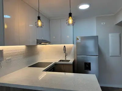 a kitchen with a sink and a refrigerator at Exclusive apartment Barranco! in Lima