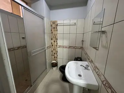 a bathroom with a sink and a shower at Hotel Paraiso L & M in Huánuco