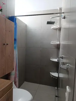 a bathroom with a shower with a toilet and a sink at casa en playa de condominio mikonos in Asia