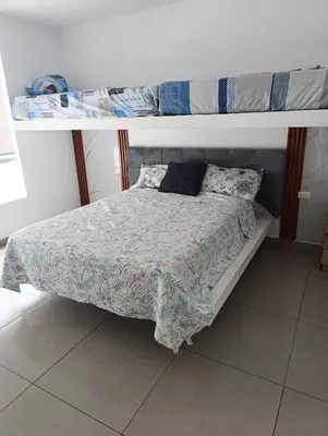 a bed in a room with two bunk beds at casa en playa de condominio mikonos in Asia