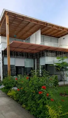 a building with awning and flowers in front of it at casa en playa de condominio mikonos in Asia