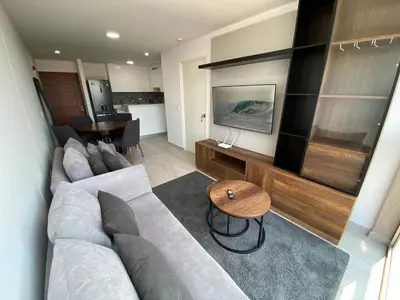 a living room with a large couch and a table at Monumental BR1 in Lima