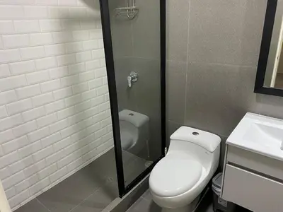 a bathroom with a toilet and a shower and a sink at Monumental BR1 in Lima