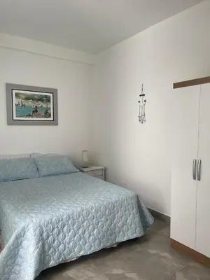 a bedroom with a bed and a picture on the wall at Hermosa casa de playa Asia in Lima