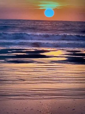 a sunset on a beach with the ocean at Hermosa casa de playa Asia in Lima
