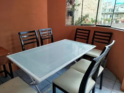 a white table and chairs in a room at Apart Hotel Valdelomar in Ayacucho