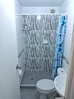 a bathroom with a shower with a toilet and a sink at CasaBlanca2 in Lima