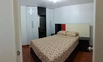 a small bedroom with a bed and a closet at CasaBlanca2 in Lima