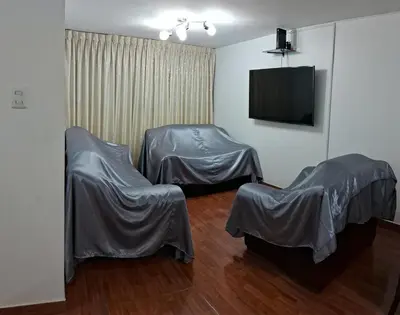 a room with two chairs and a flat screen tv at CasaBlanca2 in Lima