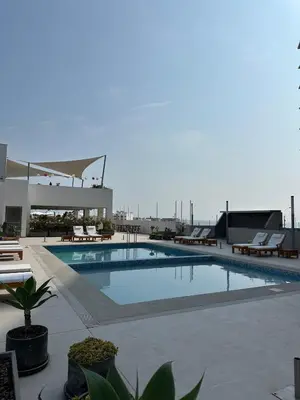 a swimming pool on the roof of a building at Departamento en San Bartolo in San Bartolo