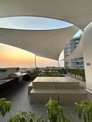 a building with a large white canopy over a patio at Departamento en San Bartolo in San Bartolo