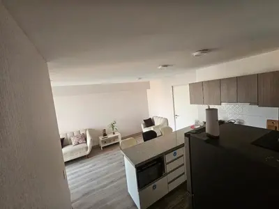 a kitchen and a living room with a couch at Departamento con Increíble ubicación en San Miguel in Lima