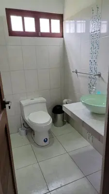 a bathroom with a toilet and a sink at Country house in Pachacamac in Lima