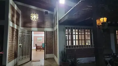 a hallway of a building with a door and a chandelier at Country house in Pachacamac in Lima