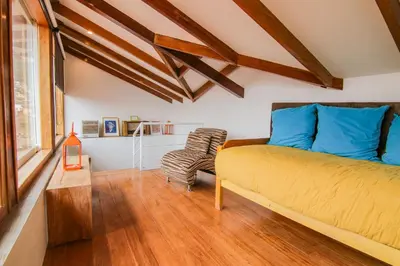 a bedroom with a bed and a wooden floor at QOSQO BELVEDERE, apartamento en Cuesta San Blas in Cusco