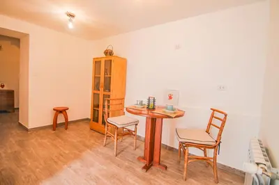 a room with a table and chairs and a cabinet at QOSQO BELVEDERE, apartamento en Cuesta San Blas in Cusco