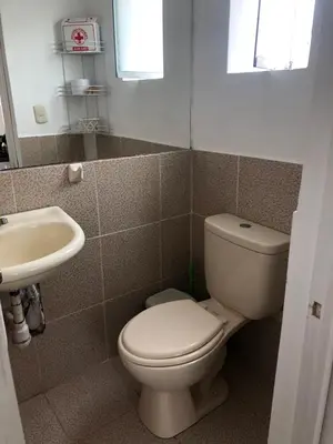 a bathroom with a toilet and a sink at Lindo departamento muy cerca a la playa in Punta Negra