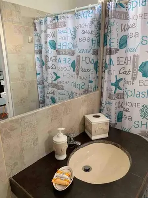a bathroom with a sink and a mirror at Mini Dpto frente al mar playa Pta N in Punta Negra