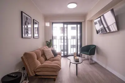 a living room with a couch and a chair at Barranco Moderno Style 1BR in Lima