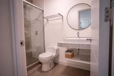 a bathroom with a toilet and a sink and a mirror at Barranco Moderno Style 1BR in Lima