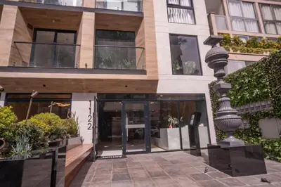 an external view of a building with a glass door at Barranco Moderno Style 1BR in Lima
