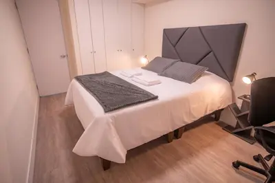 a bedroom with a large bed with a large headboard at Barranco Moderno Style 1BR in Lima