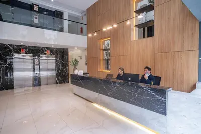 two people sitting at a counter in a lobby at Barranco Moderno Style 1BR in Lima
