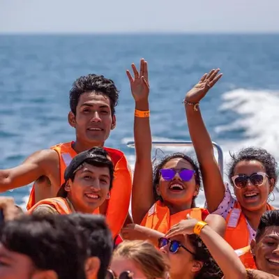 a group of people on a boat in the water at Atenas Backpacker Hospedaje in Paracas