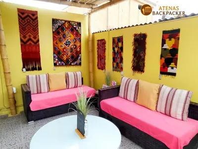 a room with two couches and a table at Atenas Backpacker Hospedaje in Paracas