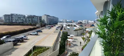 a city street with cars parked in a parking lot at Apartamento San Bartolo in San Bartolo