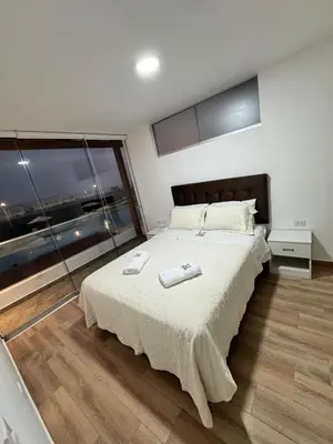 a bedroom with a large bed and a large window at Casa de Playa - Asia - SELENE beach house in Asia