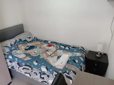 a bed with a wii remote on top of it at Apartment in San Isidro in Lima