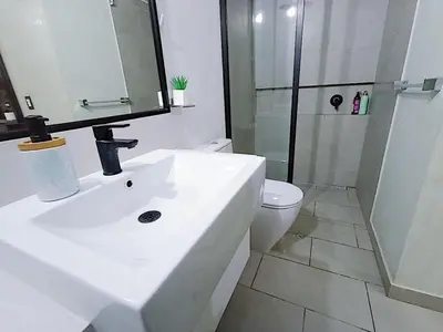 a bathroom with a sink and a toilet and a shower at 2BR Deluxe Apartment in San Isidro in Lima