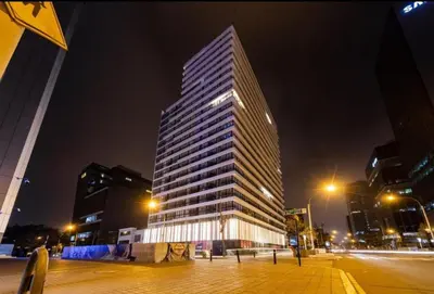 a tall building in a city at night at 2BR Deluxe Apartment in San Isidro in Lima