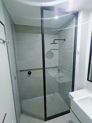 a glass shower in a bathroom with a sink at 2BR Deluxe Apartment in San Isidro in Lima